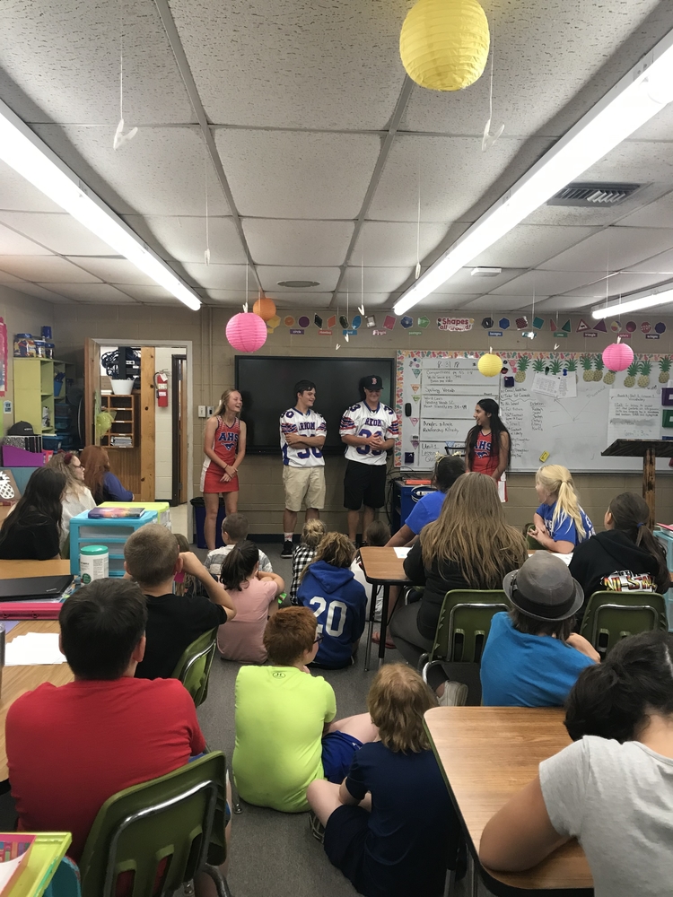 Elementary students “adopt” football players and cheerleaders 